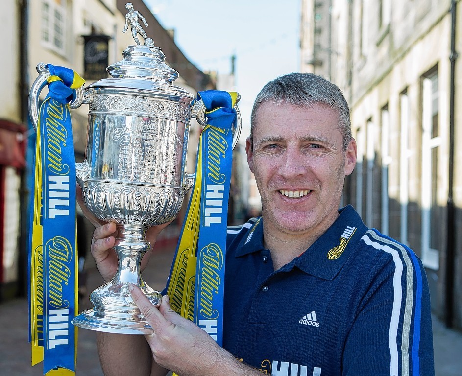 Barry Wilson gets his hands on the Scottish Cup