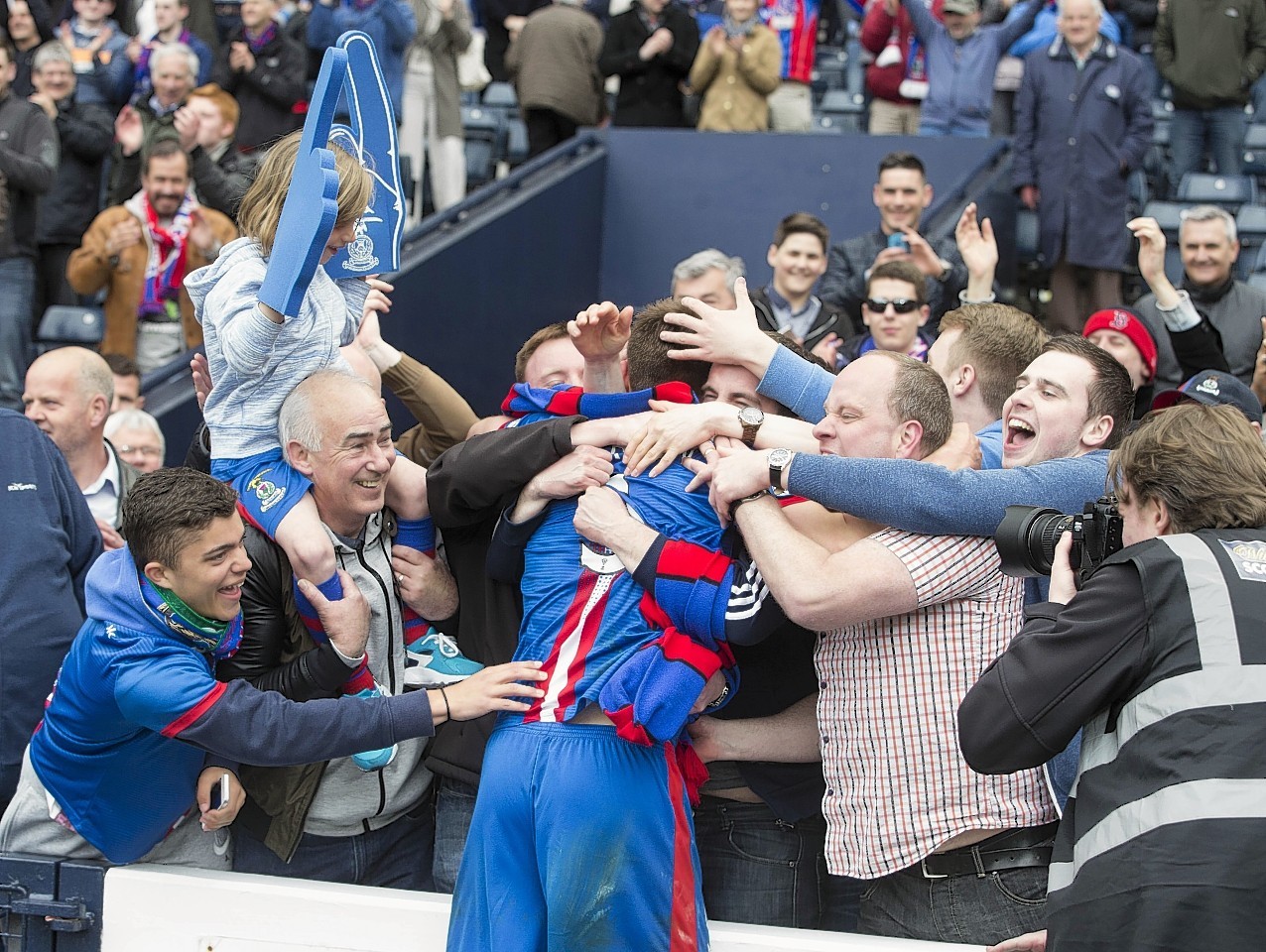 Inverness's Gary Warren celebrates with fans