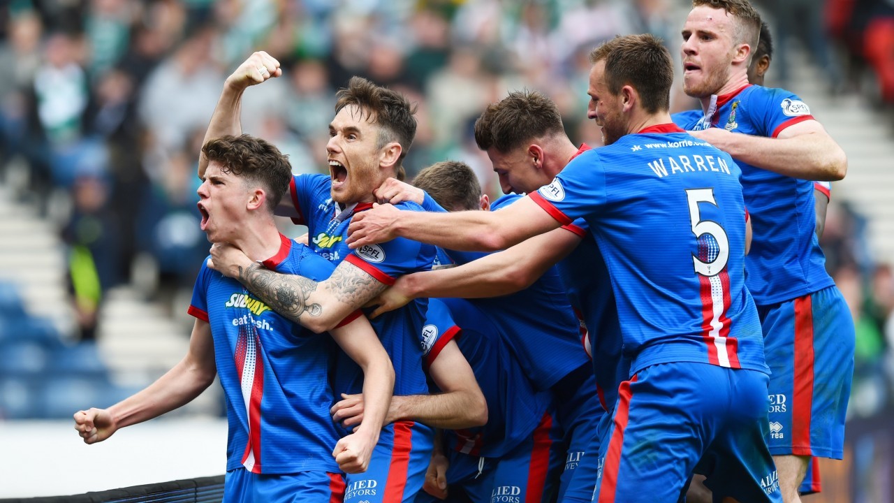 Caley Thistle players celebare Raven's winner. Raven is hidden somewhere in there, honest!