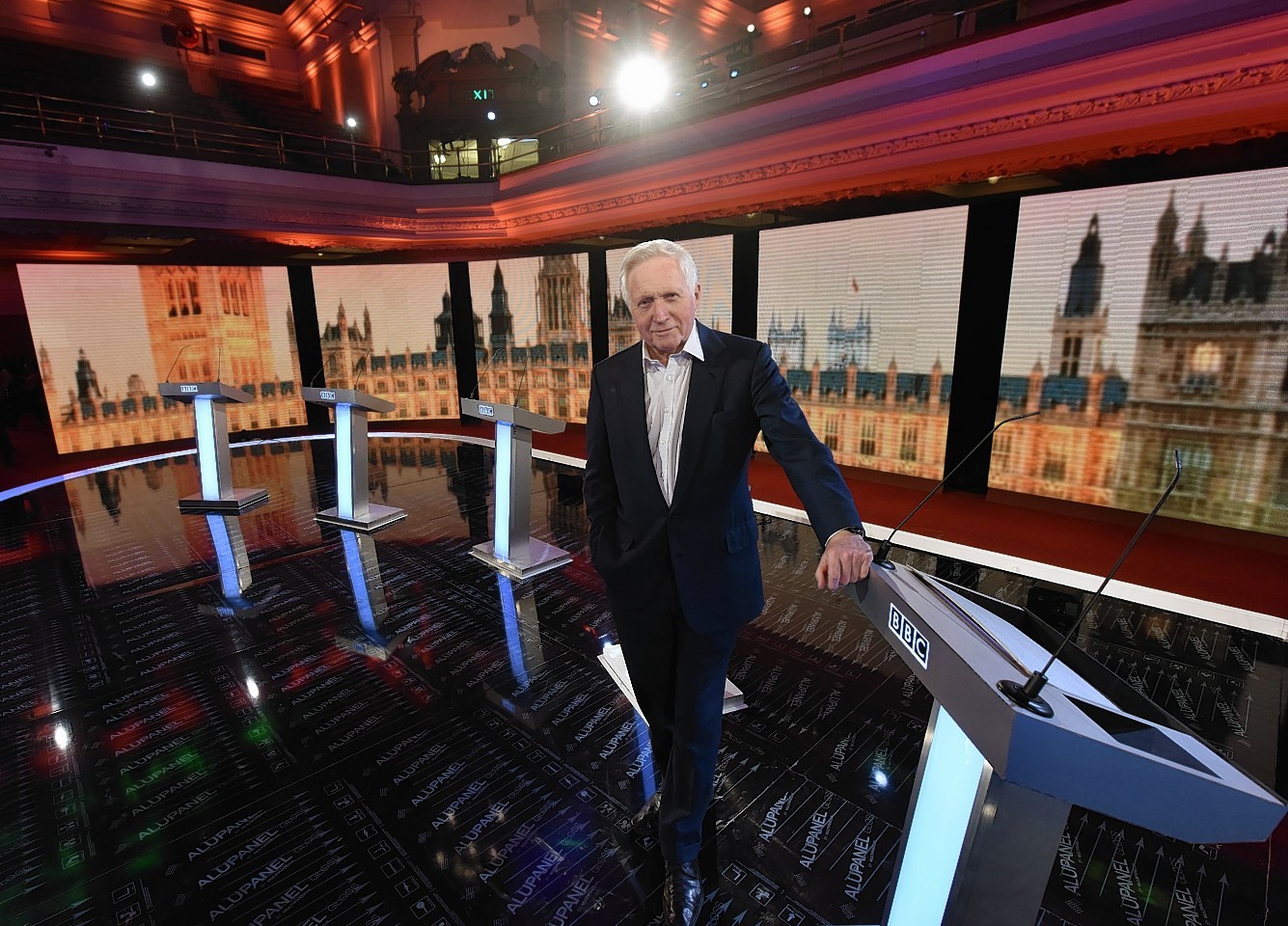 Presenter David Dimbleby gets ready to host this evening's debate