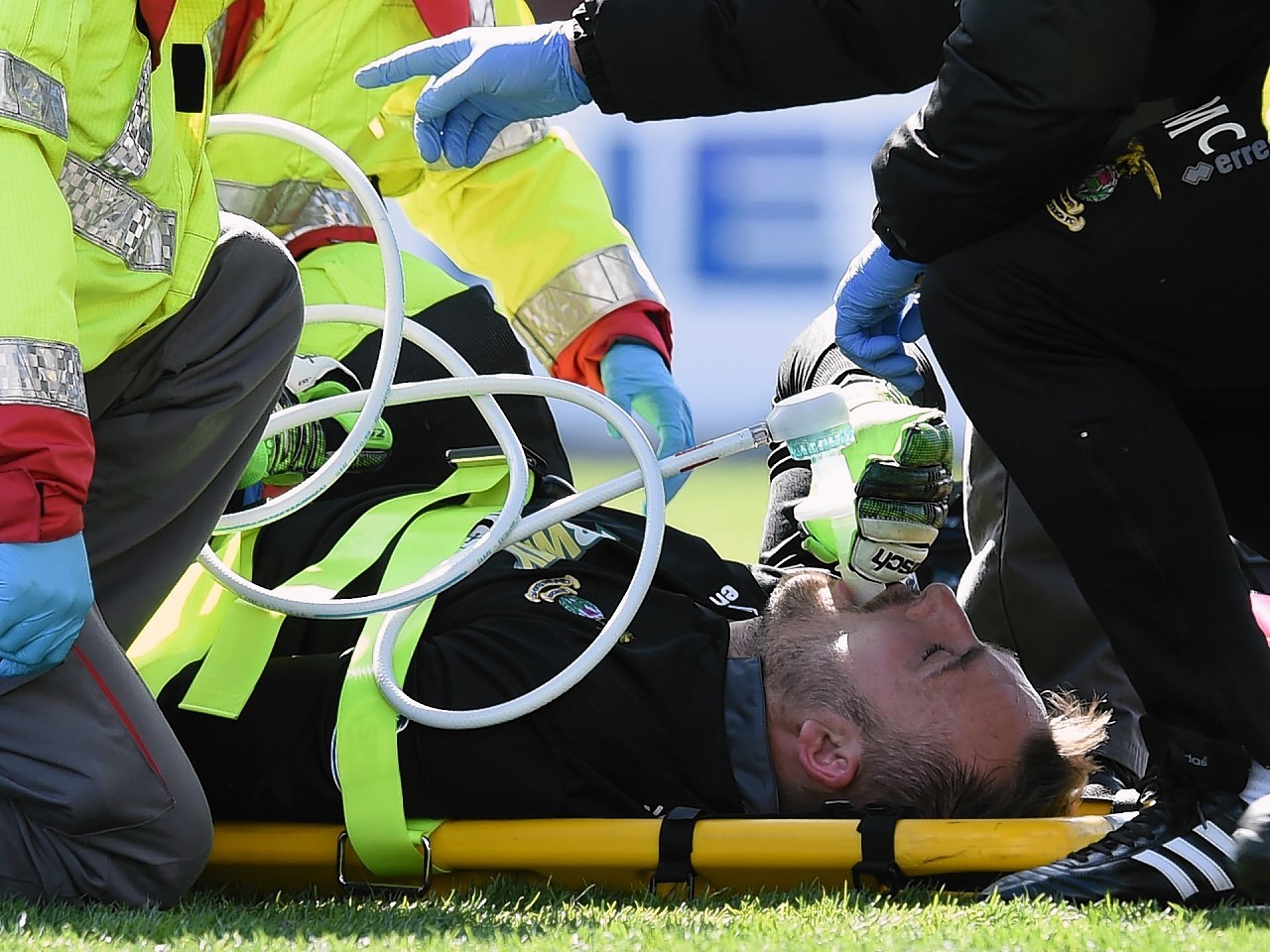 Dean Brill had to receive oxygen on the pitch following a suspected dislocated knee cap