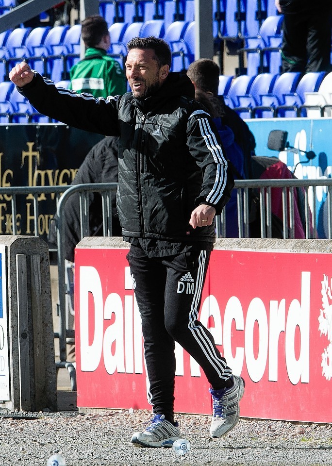 McInnes celebrates as the Dons take the lead against Caley Thistle