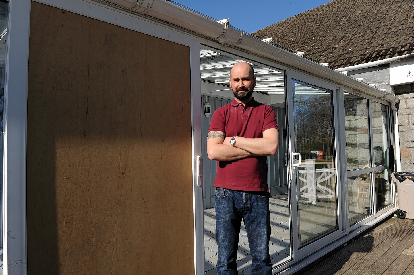 Manager Justin Barnett at the damaged door of the cafe.