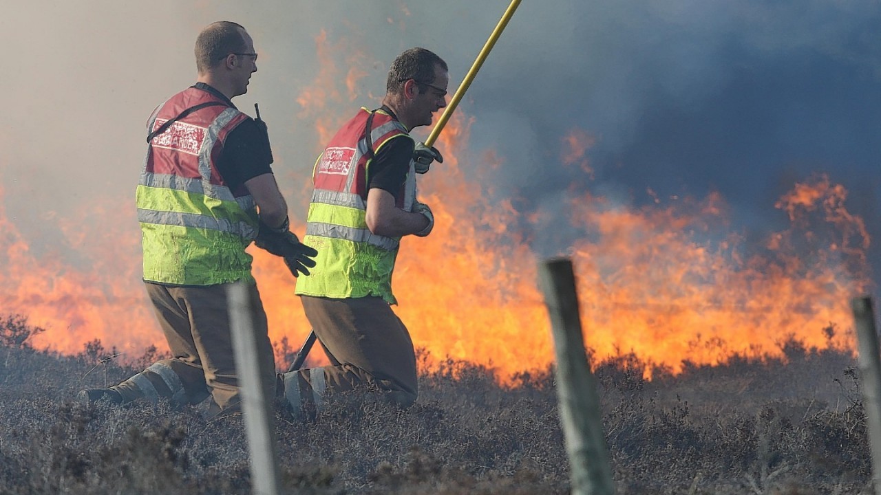 Firefighters tackle the large moorland fire near Inverness