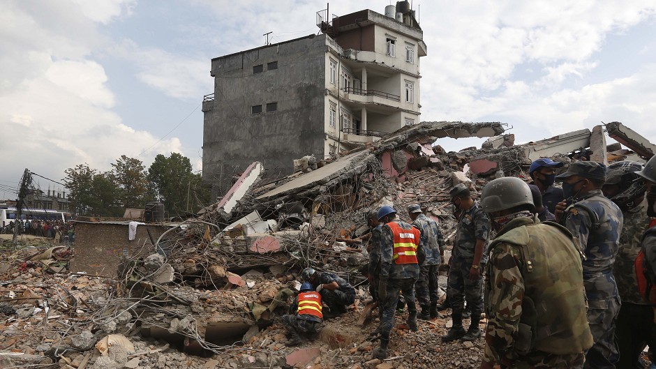 Police look for survivors in the debris of a building that collapsed in an earthquake in Kathmandu, Nepal (AP)