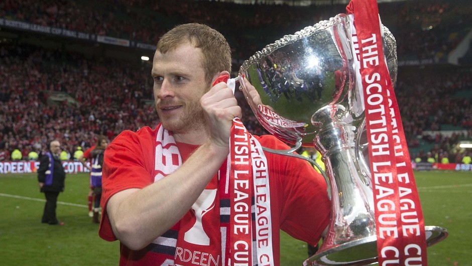 Ex-Dons defender Mark Reynolds with the League Cup  in 2014.