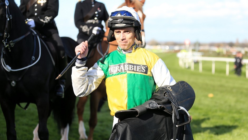 Jockey Leighton Aspell celebrates after victory in the Crabbie's Grand National Chase on Many Clouds