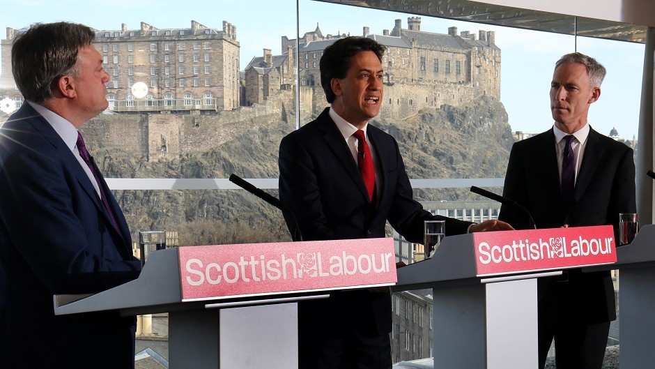 Labour leader Ed Miliband, centre, speaking alongside Ed Balls, left and Jim Murphy, has accused the Tories of sinking into personal abuse