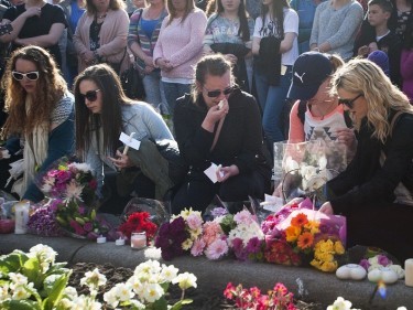 People place flowers and candles during a vigil in Glasgow for Karen Buckley 