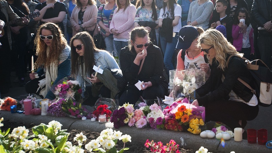 People place flowers and candles during a vigil in Glasgow for Karen Buckley 