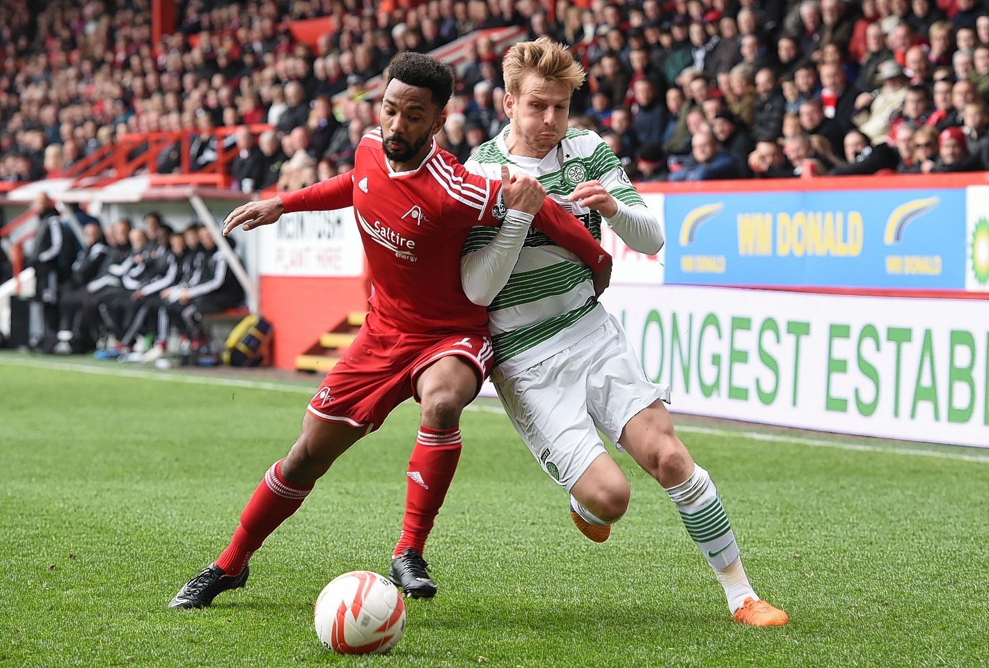 Aberdeen defender Shay Logan goes up against Stuart Armstrong