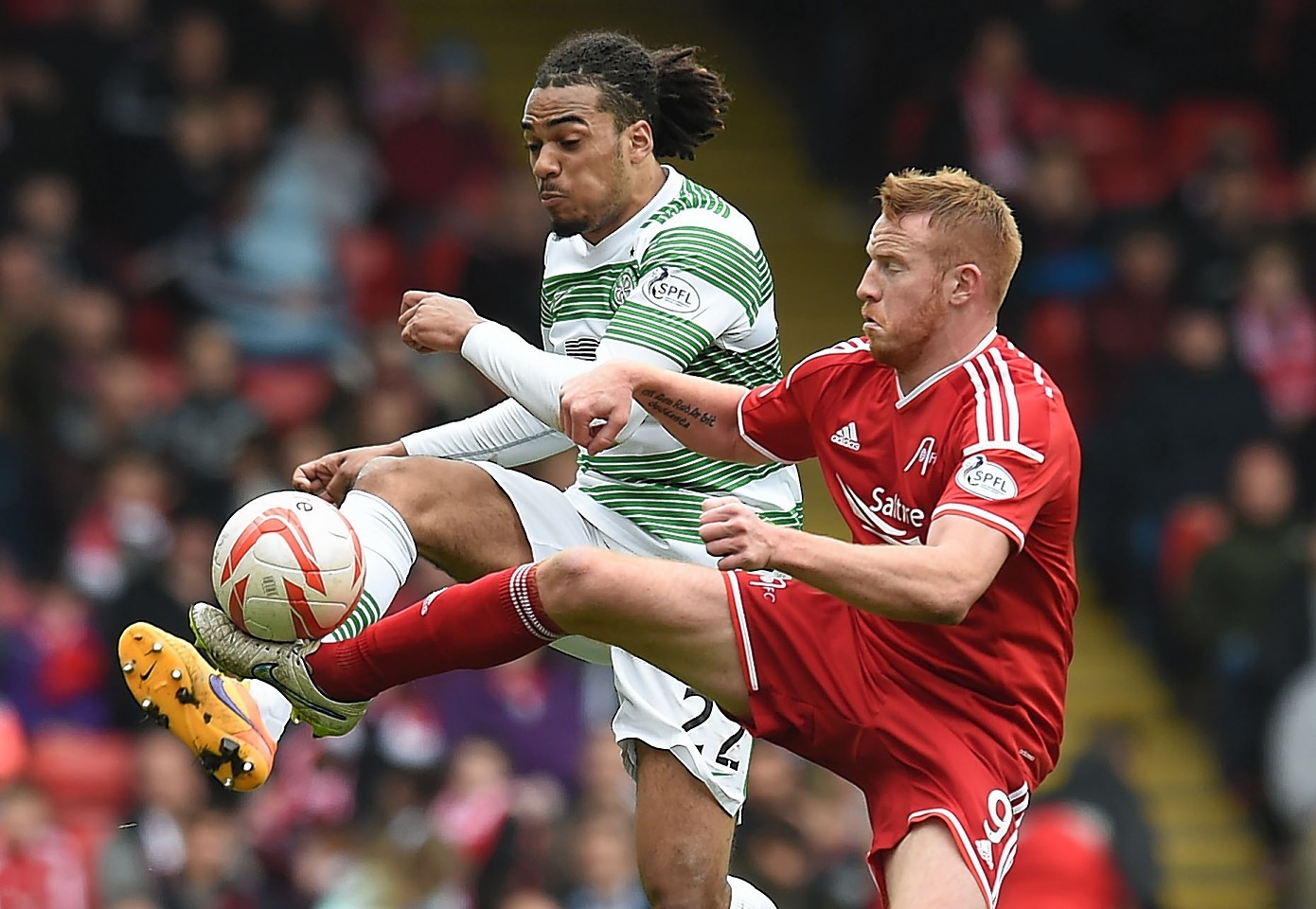 Adam Rooney (right) competes for the loose ball against Celtic's Jason Denayer