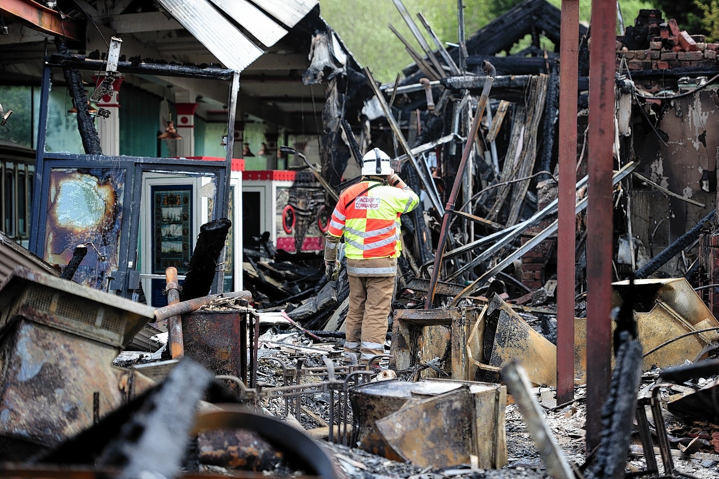 Firefighter surveys damage at the Old Royal Station, Ballater