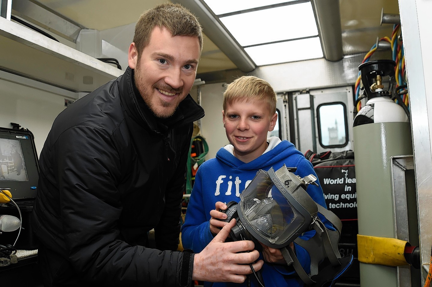 12-year-old Connor Downie is shown around the unit by Marcus van der Laan