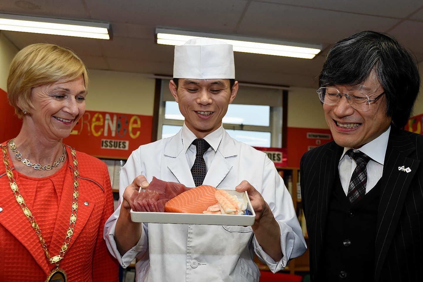 Chef Yuki Hamasaki shows the ingredients to Hajime Kitaoka and Jill Webster