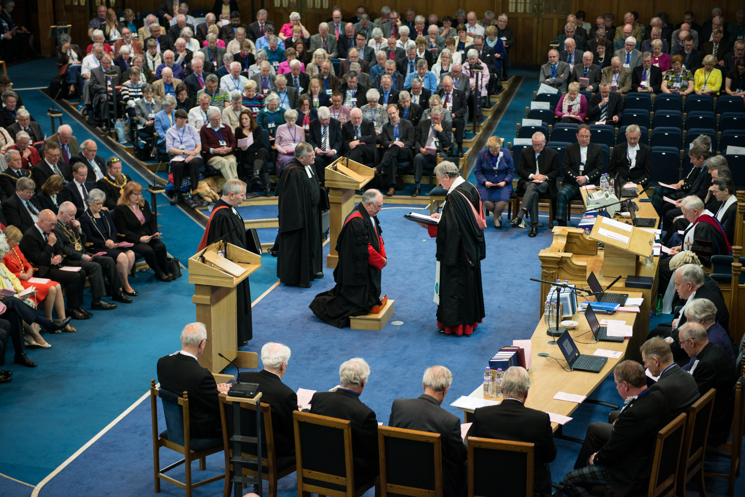 Outgoing moderator the  Very Rev John Chalmers hands over the reins to his successor the Right Rev Angus Morrison (kneeling)