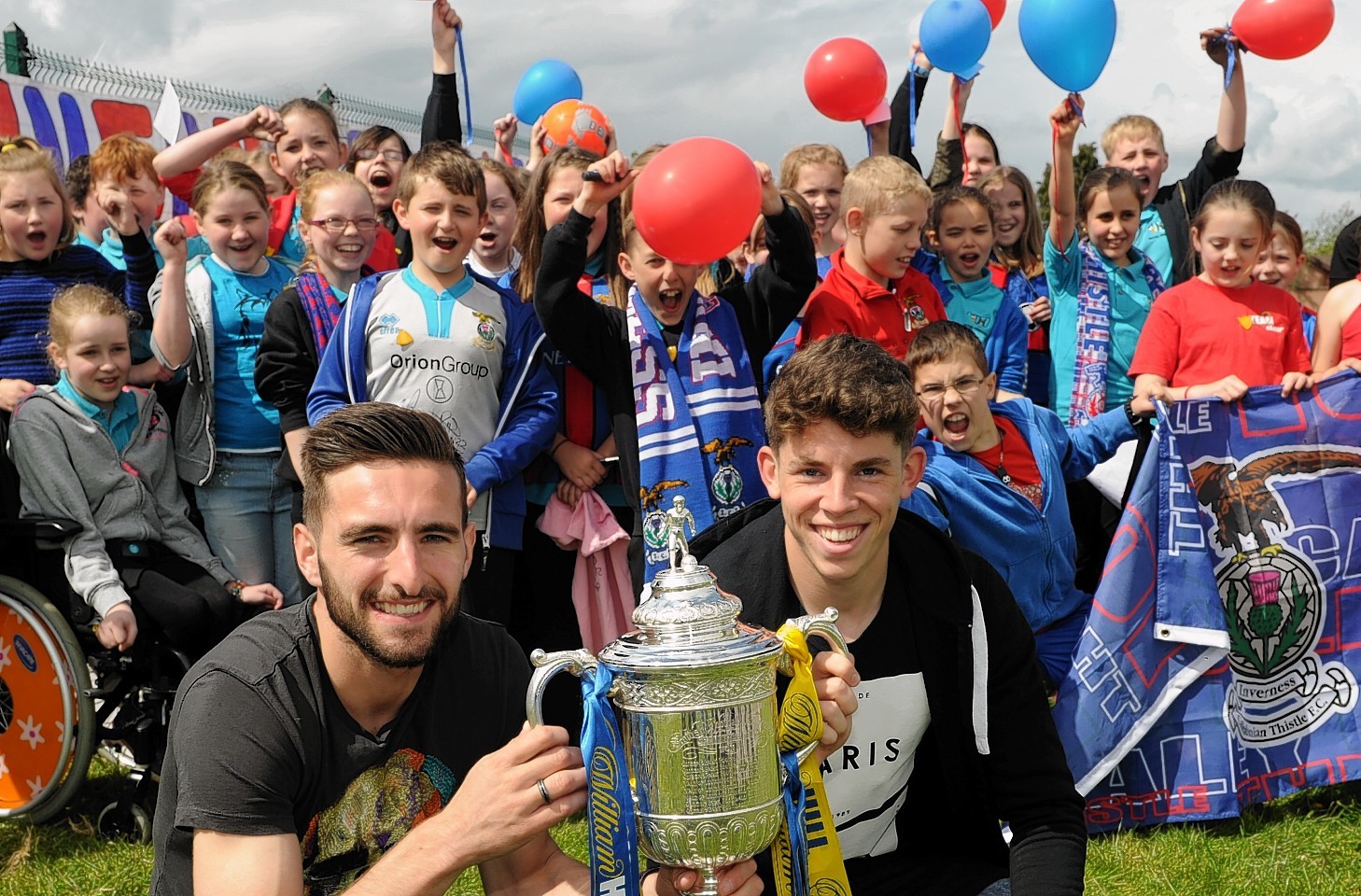 Graeme Shinnie and Ryan Christie with a local primary school and the Scottish Cup