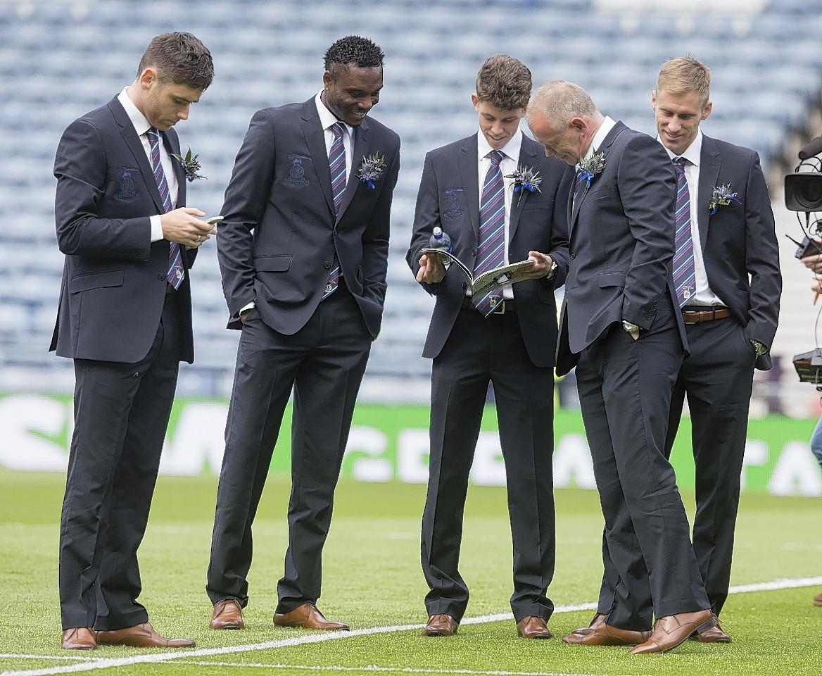John Hughes and the Caley Thistle squad take to the Hampden pitch to read what the programme has to say about them