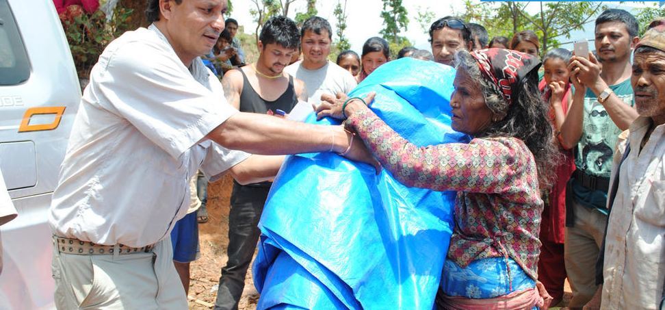 Associate of Himalayan Initiatives - Kumar Karki - handing out aid in one of the affected villages in Nepal