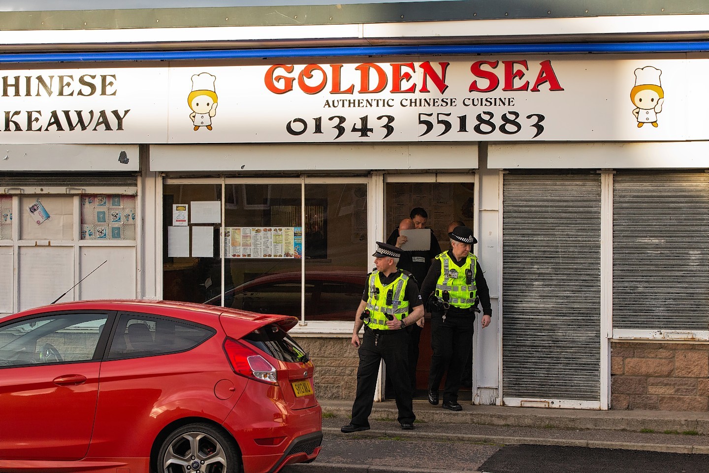 Officers at the Golden Sea restaurant in Elgin