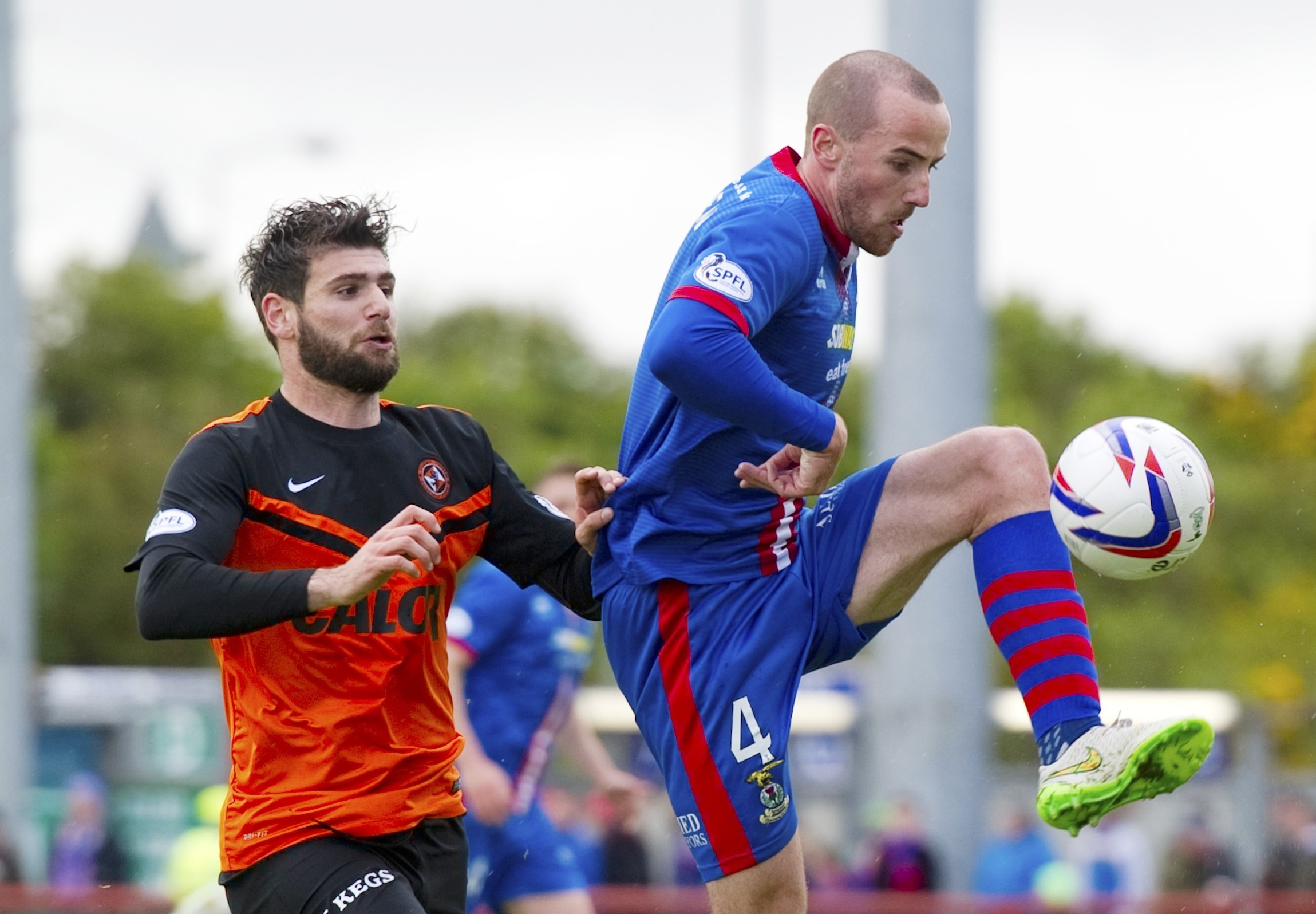 Caley Thistle's James Vincent clears from Dundee United's Nadir Ciftci