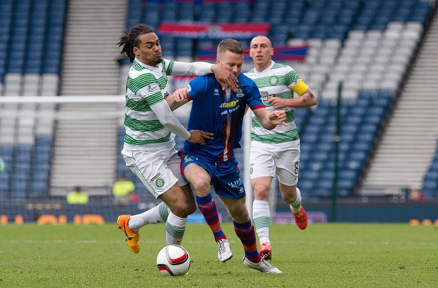 Celtic's Jason Denayer challenges Caley Thistle winger Marley Watkins