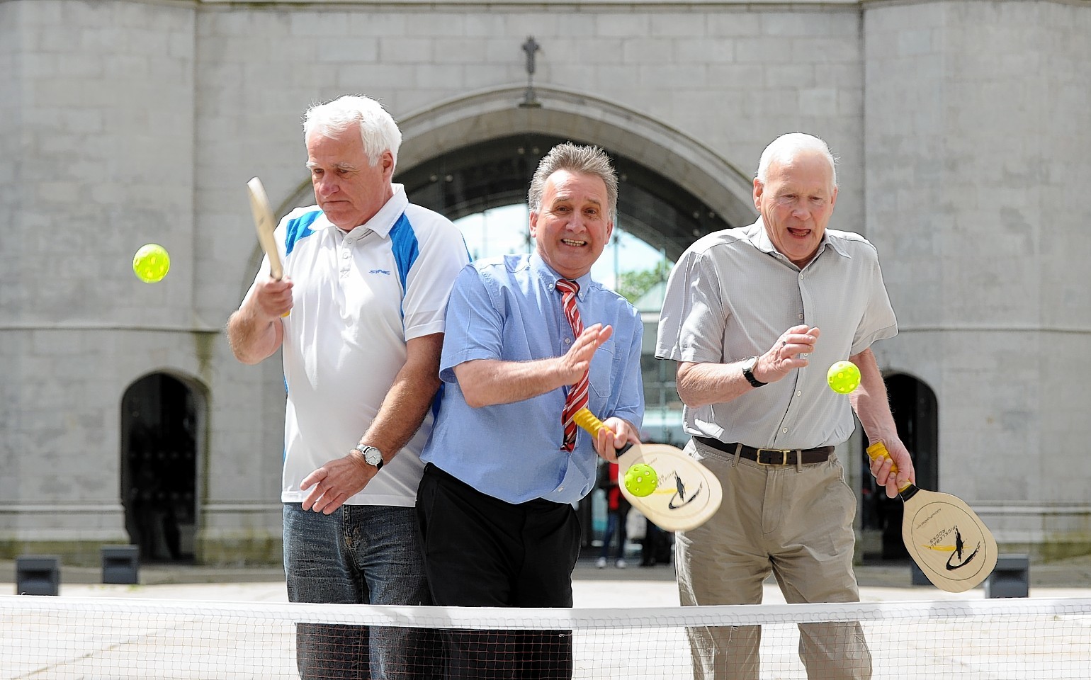 George Yule, executive vice chairman of Aberdeen Football Club, playing pickleball with Peter Ewen (left) and Adam Chisholm at the launch of Golden Games 2015 at Marischal College Quad. Picture by Kevin Emslie
