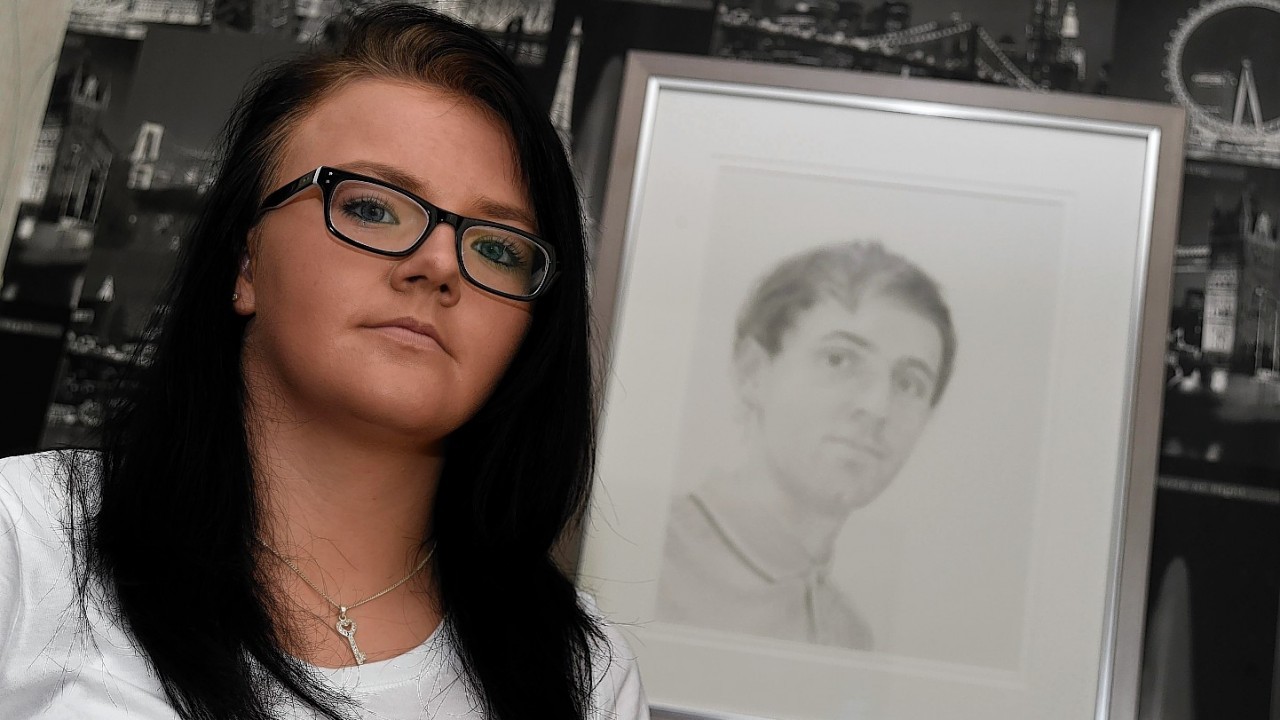 Nicola Shand with a portrait of her brother Shaun Ritchie