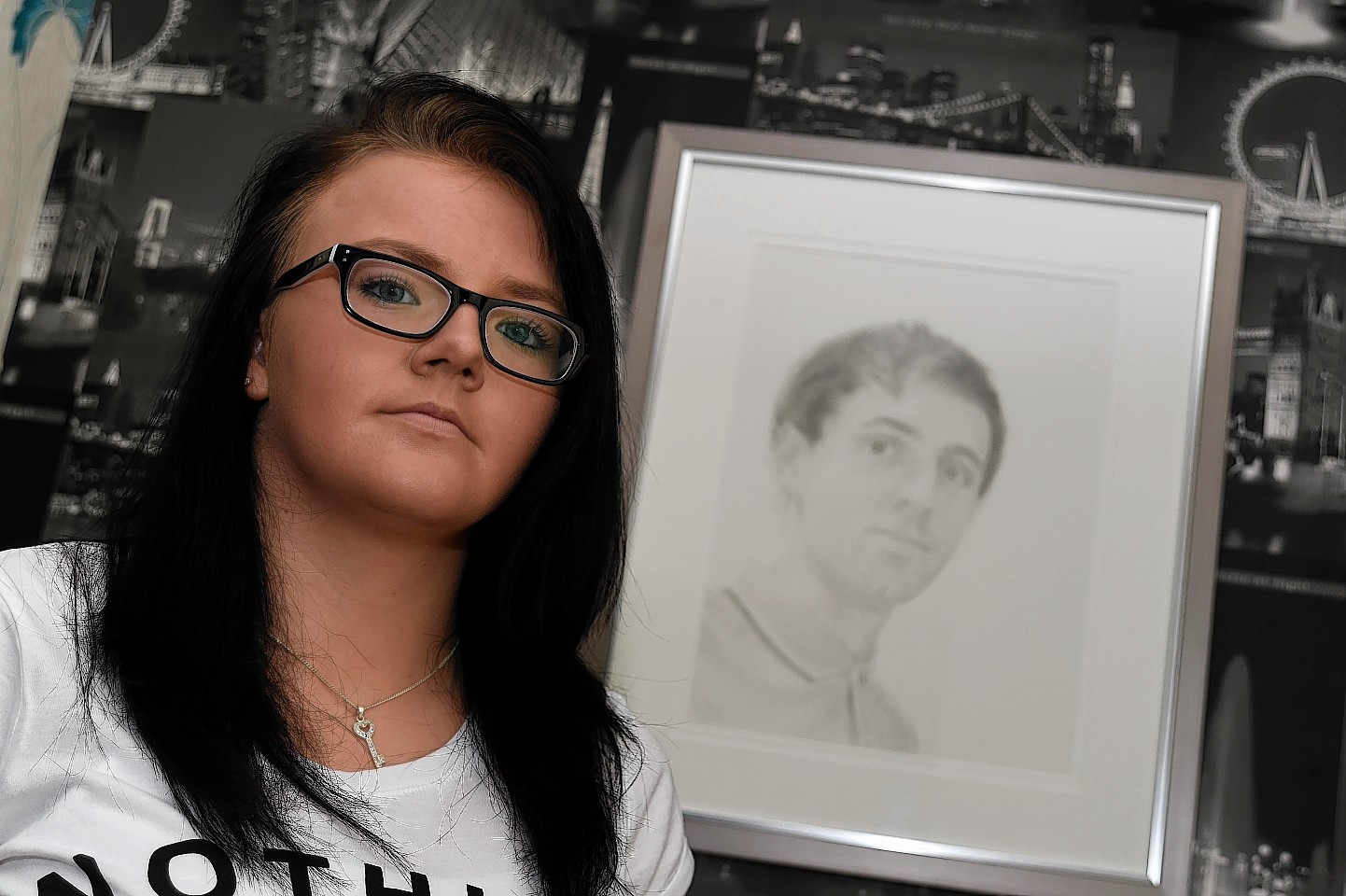 Nicola Shand with a portrait of her brother Shaun Ritchie