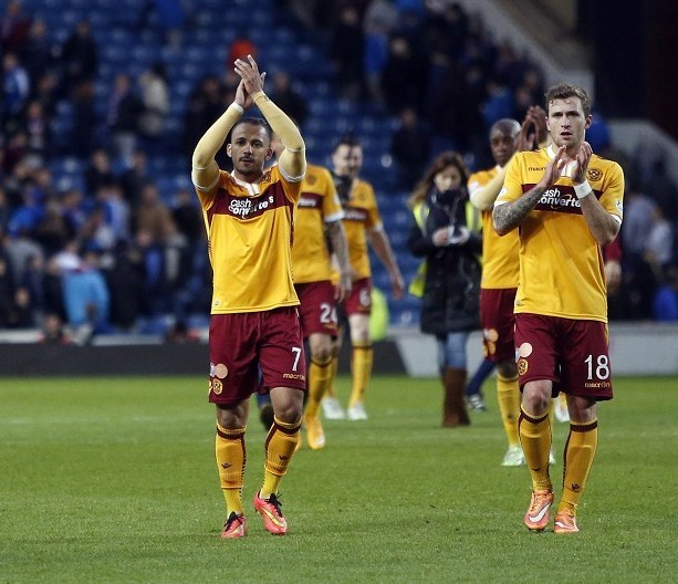 The Motherwell players applaud their fans after their Ibrox first leg triumph