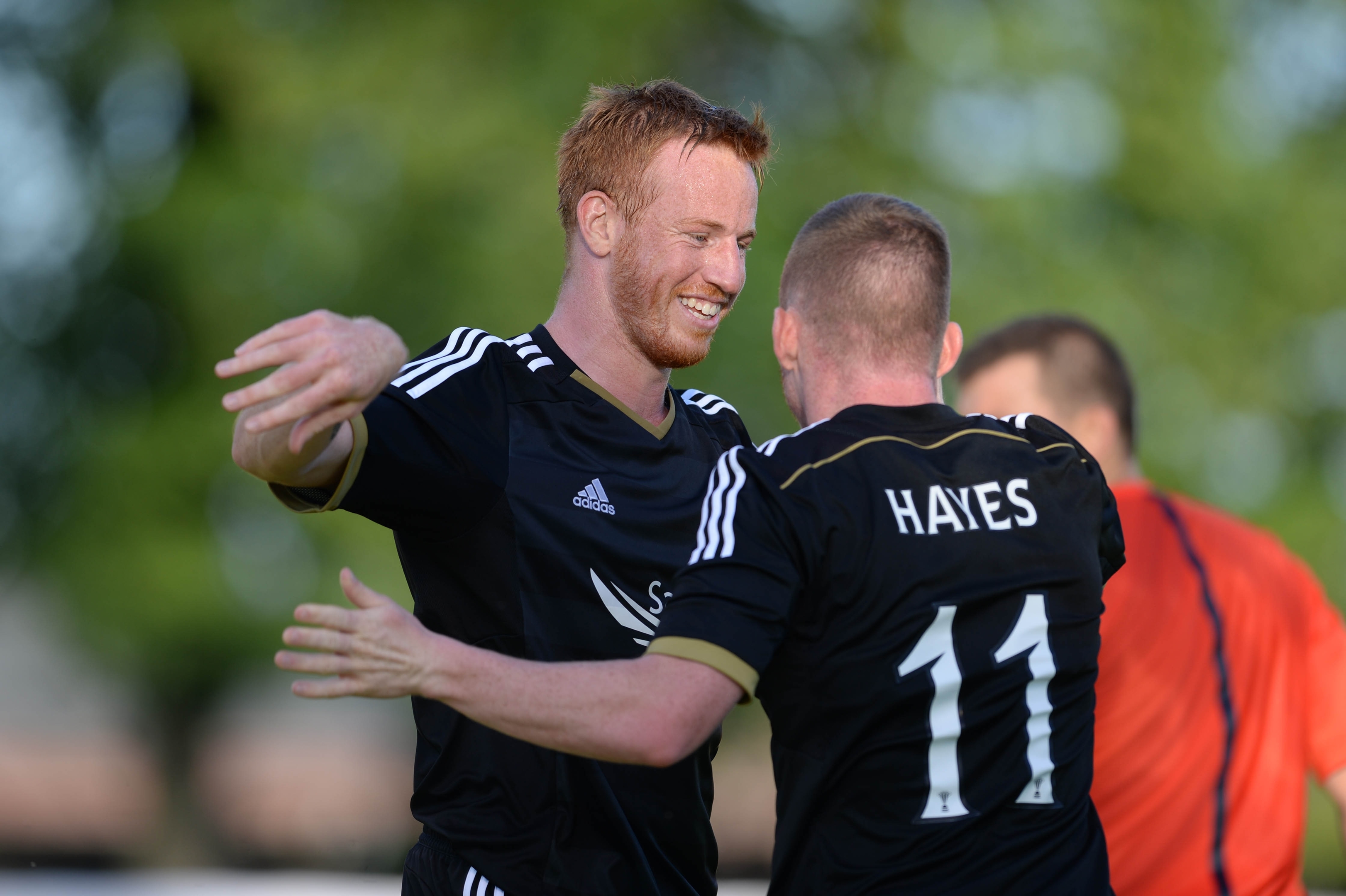 Adam Rooney celebrates a goal with former Dons team-mate Jonny Hayes