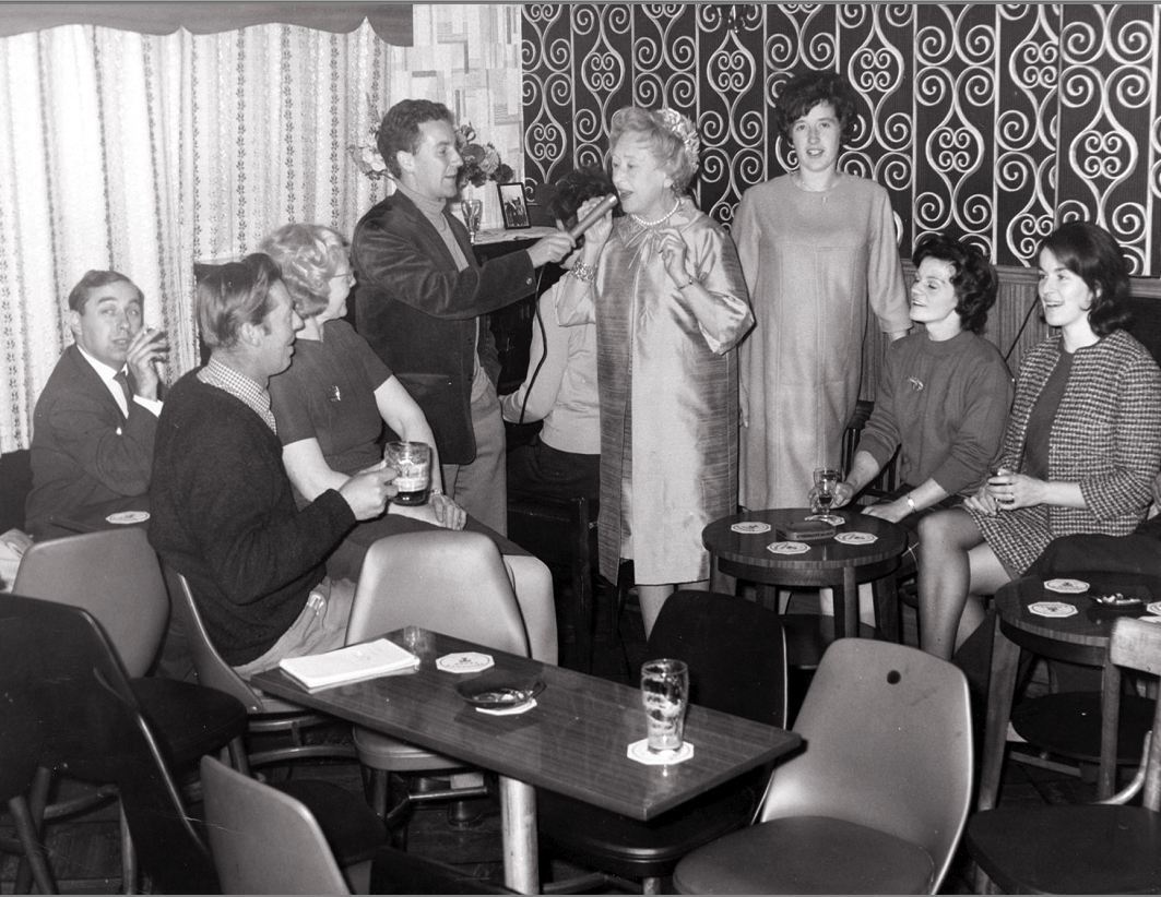 Photograph of the Garlogie Bar in 1967 when Annie Walker from Coronation Street was a the guest personality at the Garlogie Stock Car Racing. (L to R) Annie Walkers Driver/minder, Cameron Ormiston, Annie Mackie,Robbie Shepard, Esma Shepard, Annie Walker, Margaret Allan, Nan Anderson and Olive Ormiston.