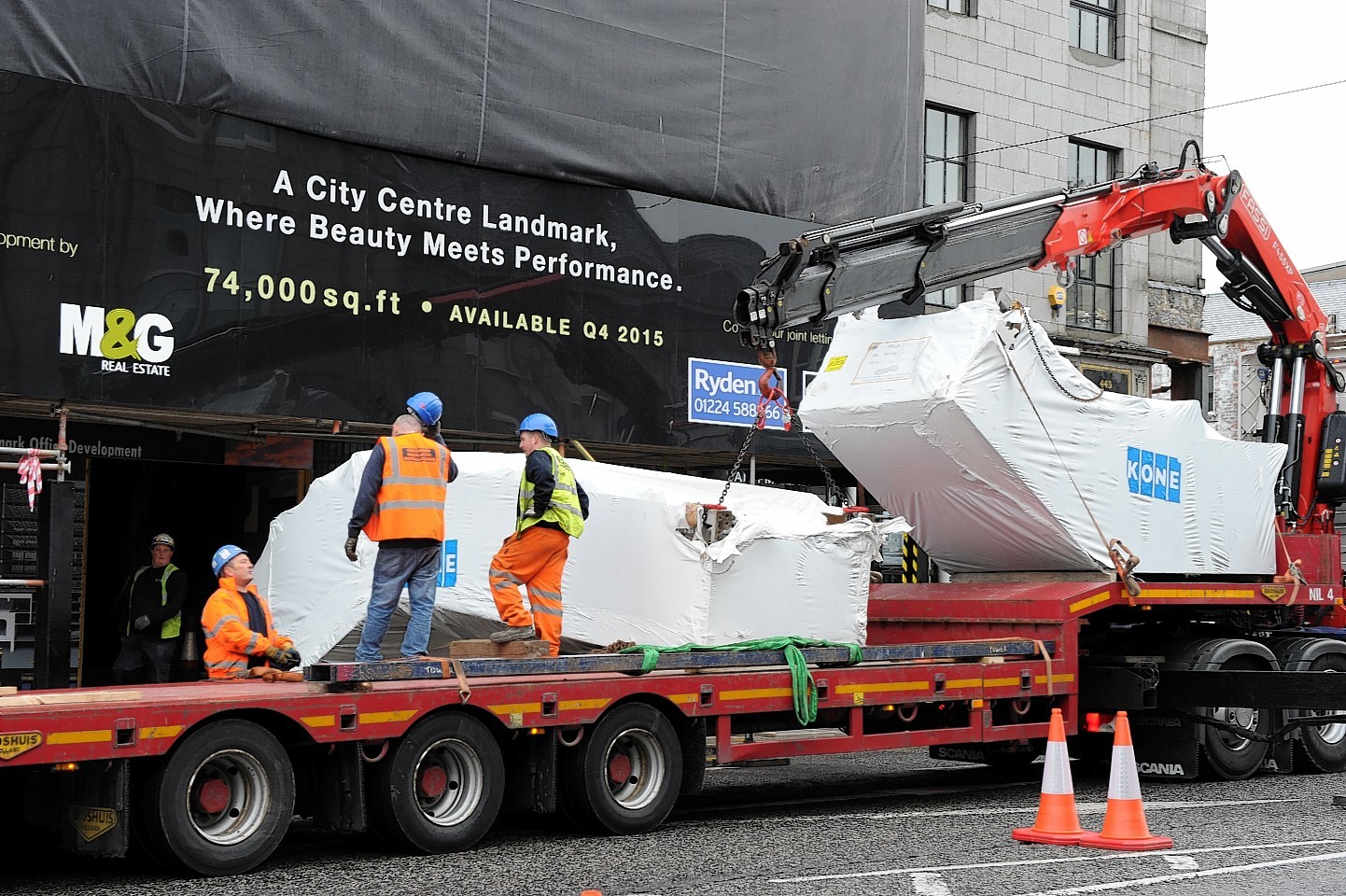 Andrew Cowie construction teams begin unloading the escalators