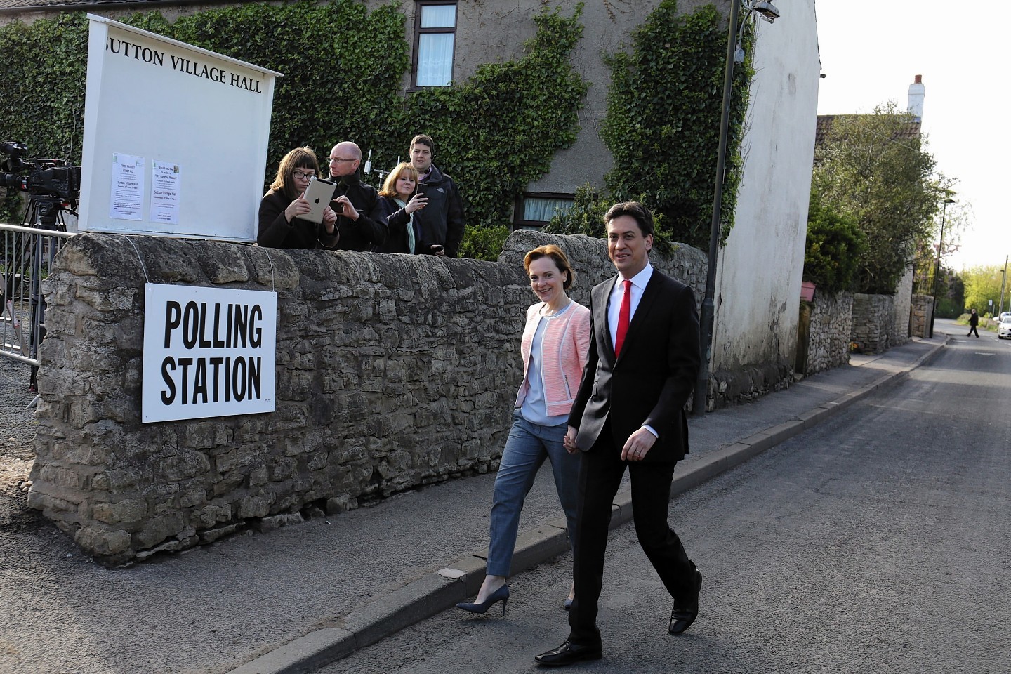 Labour Party leader Ed Miliband and his wife Justine arrive to cast their votes at Sutton village hall in Doncaster, as Britain goes to the ballot box today