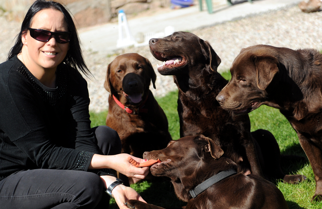 Lynda Hall in the garden of her home in Archiestown with her four chocolate Labradors, Nessie, Pickles, Millie and Darcy.