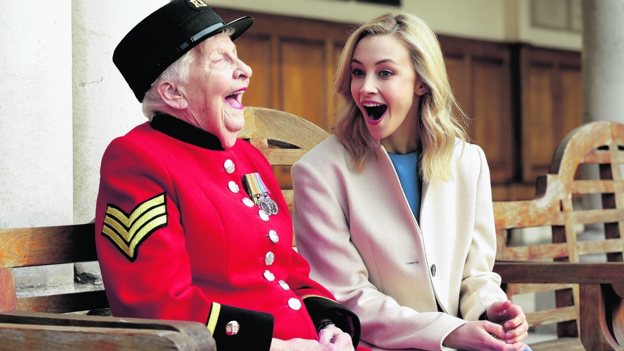 Sarah Gadon (right), star of the film A Royal Night Out, with Chelsea Pensioner Dorothy Hughes - who was one of the first female residents at the Royal Hospital and celebrated V.E. day in Trafalgar Square - during a visit to the Royal Hospital Chelsea