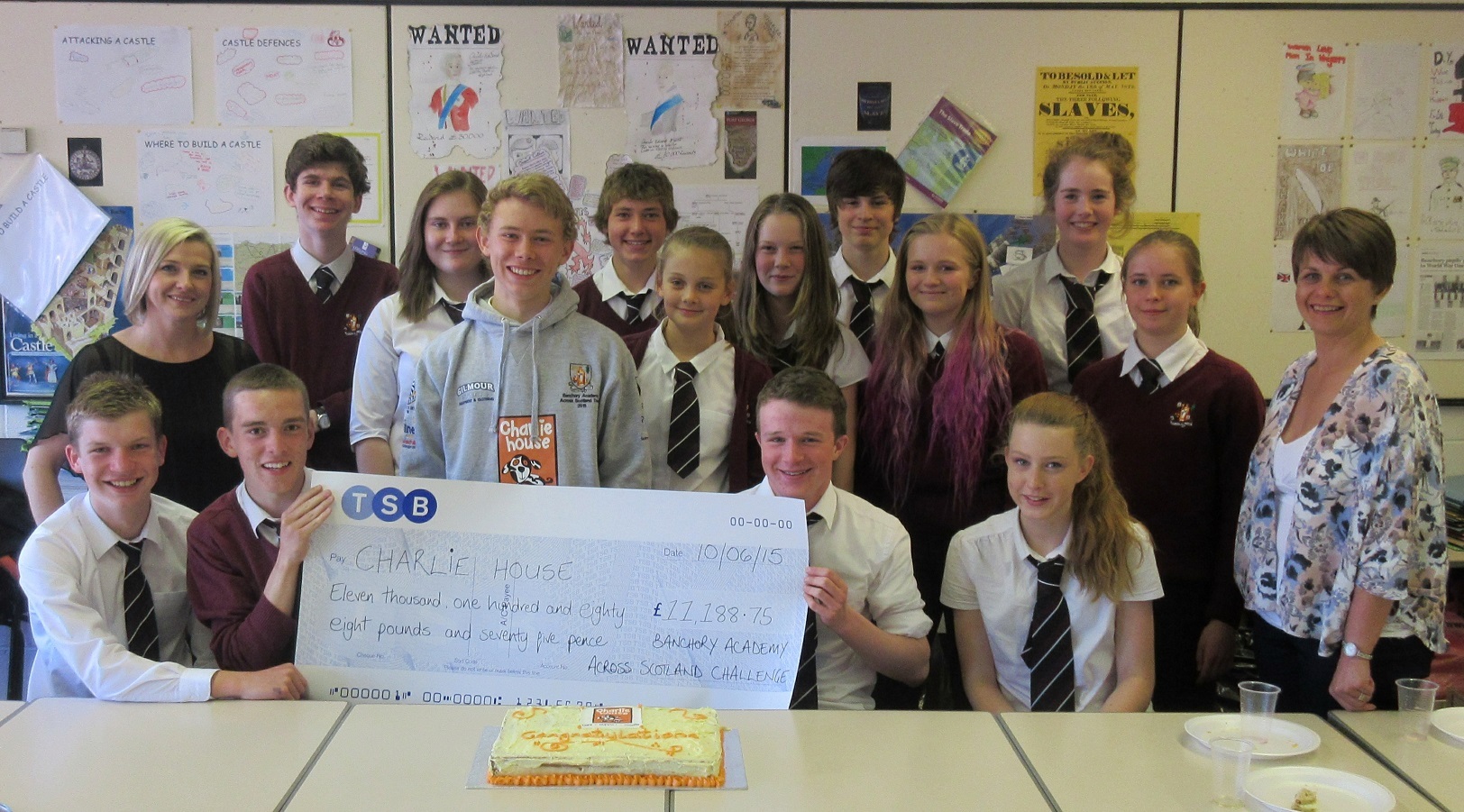 Banchory Academy pupils holding the cheque which they handed over to Charlie House following the Across Scotland challenge