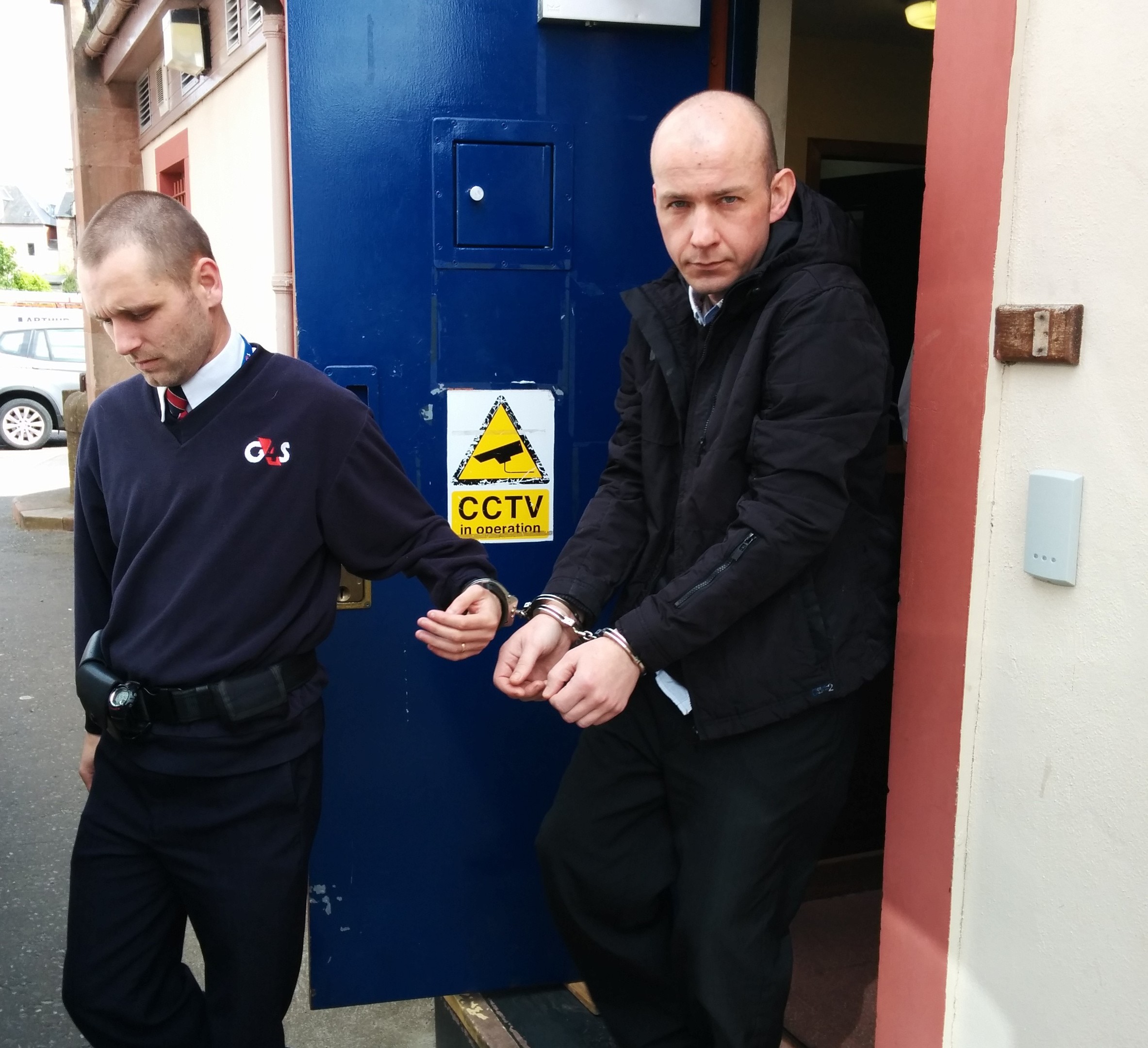 Andrew Macpherson being escorted from Inverness Sheriff Court