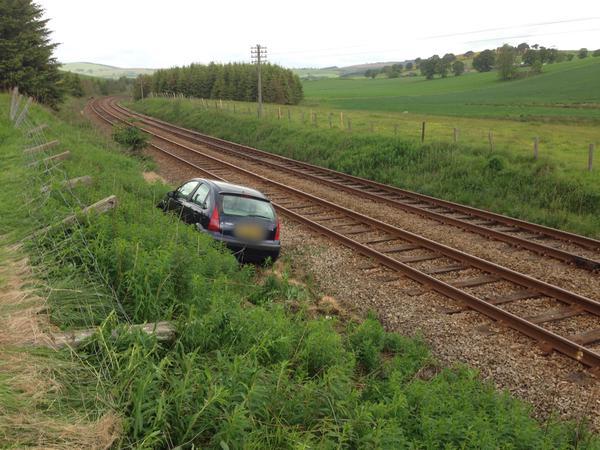 The car appears to have almost crashed onto the rail tracks