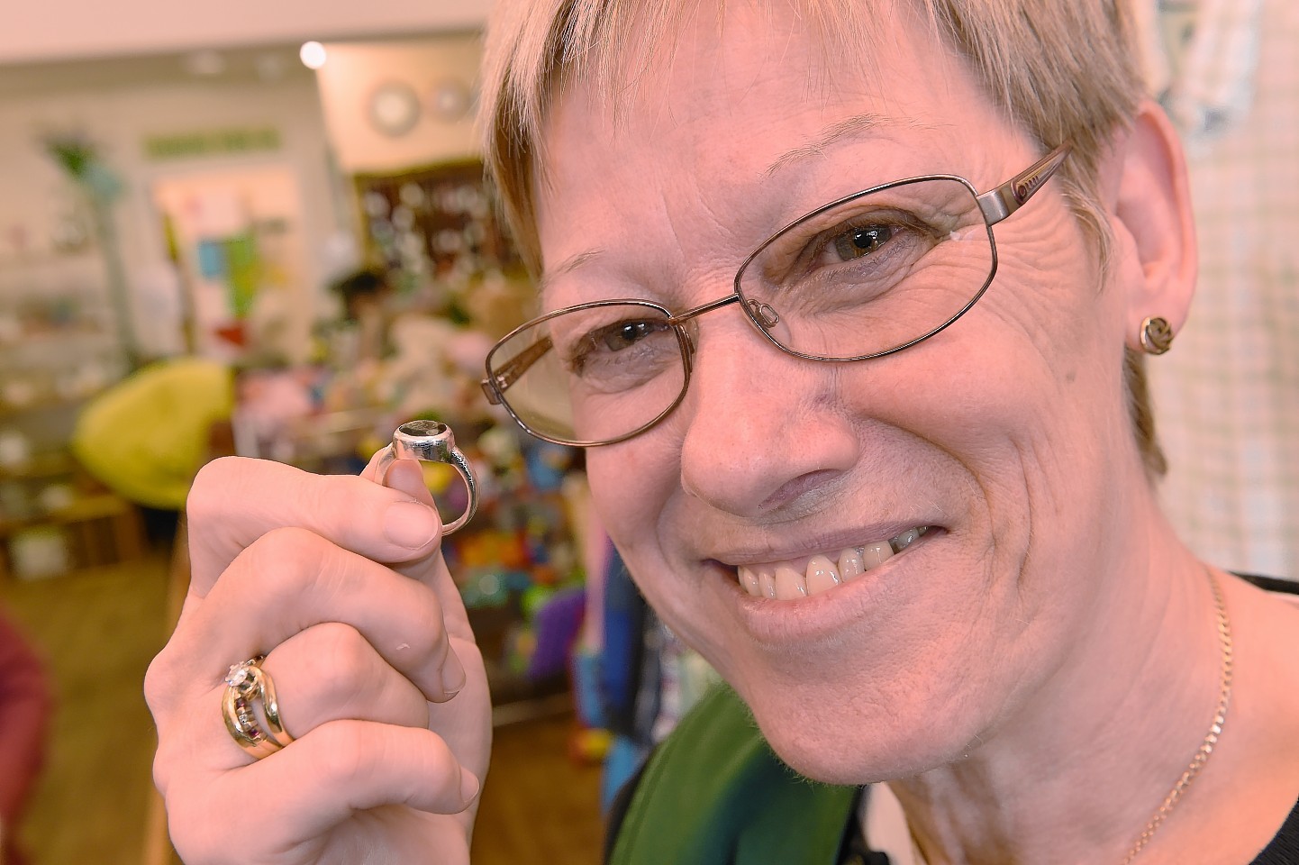 Christine Weidner of the Highland Hospice charity shop in Tain who discovered a valuable ring in a brown envelope.