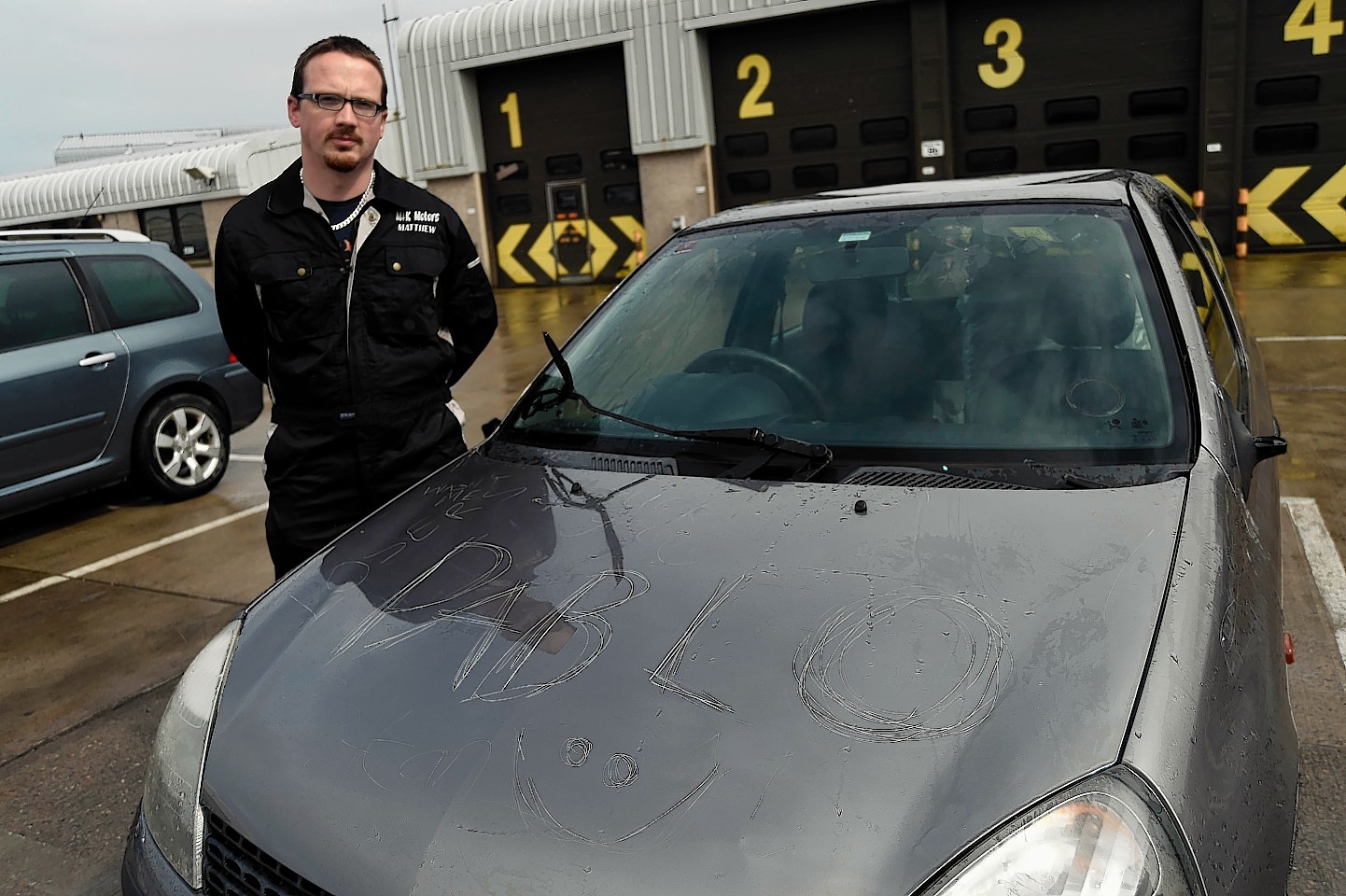 Matthew Lewis with his vandalised car