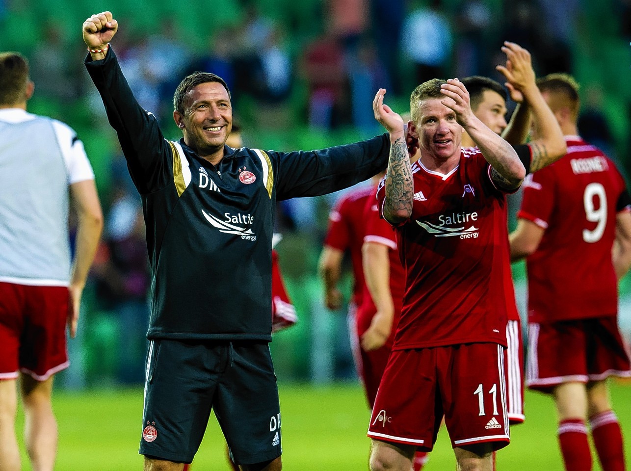 Hayes celebrates helping the Dons to European success over Groningen last season 