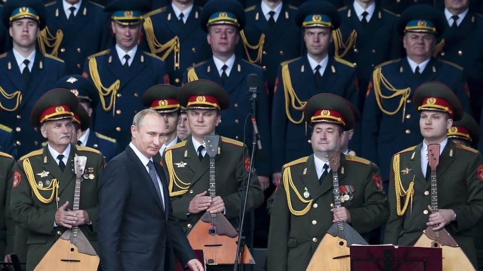 Russian president Vladimir Putin, foreground, leaves a podium after delivering his speech at the opening of the Army-2015 international military show (AP)