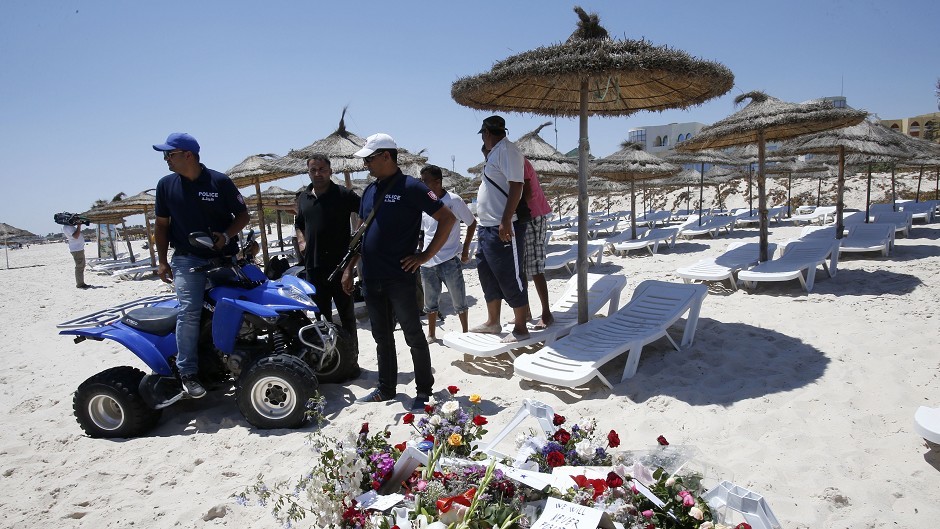 Police officers guard the scene of the attack in Sousse, Tunisia (AP)