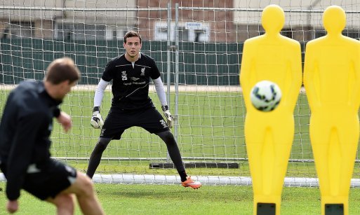 Ward faces a Steven Gerrard free kick while training with Liverpool 