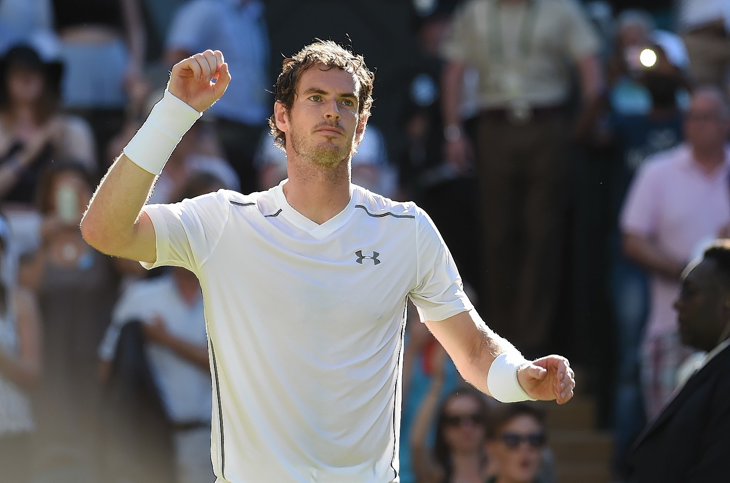 Andy Murray salutes the fans at Wimbledon as he defeats Mikhail Kukushkin by three straight sets.