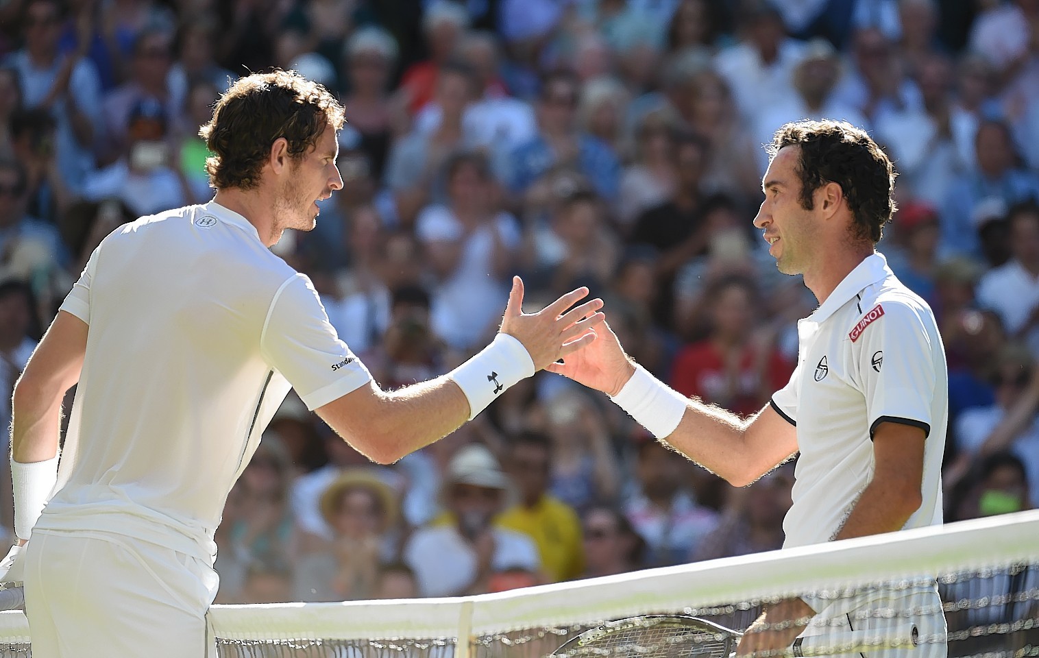 Andy Murray shakes hands with Mikhail Kukushkin after defeating him by three straight sets.