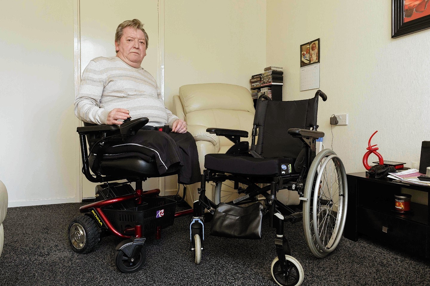 Walter Watson, 68, in the electric wheelchair which he struggled to buy himself