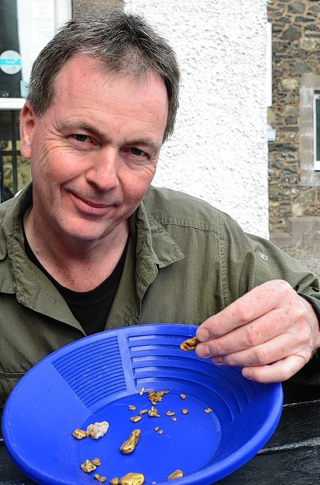 Gold panning expert Leon Kirk with the 18.13 golden nugget and his 20-year haul of panned Scottish gold. 