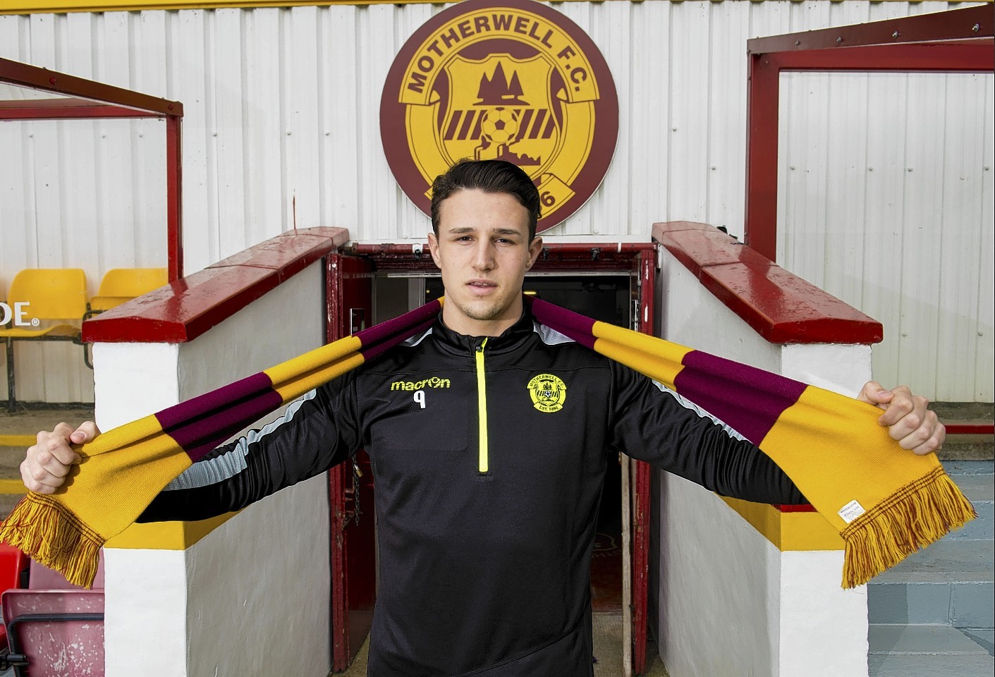 Wes Fletcher posing for photographs after signing for Motherwell 